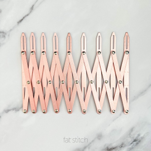 Bohin 9-Hole Buttonhole Expanding Gauge in Pink #65512